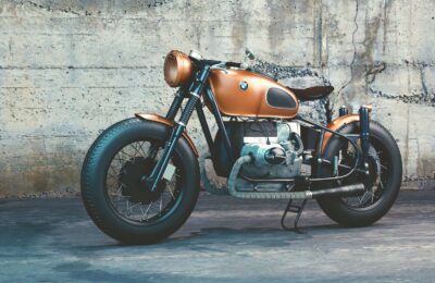 orange and black bmw motorcycle before concrete wall